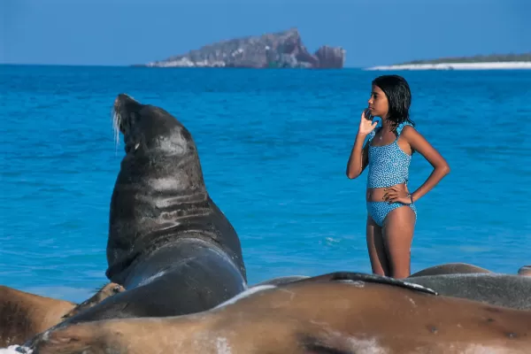 Sea lion and a young traveler soaking up the sun in the Galapagos