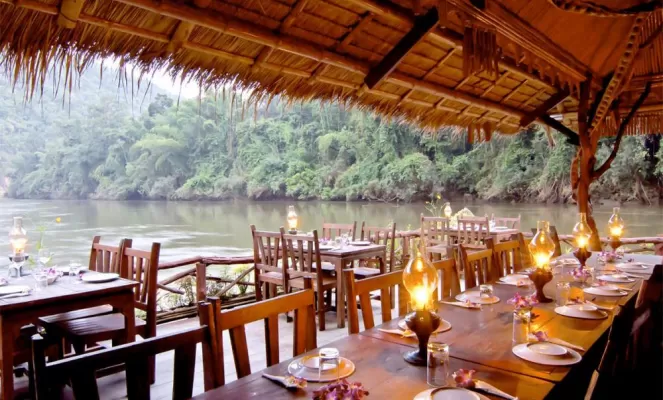 Enjoy a romantic dinner at the floating restaurant of the River Kwai Jungle Rafts Resort
