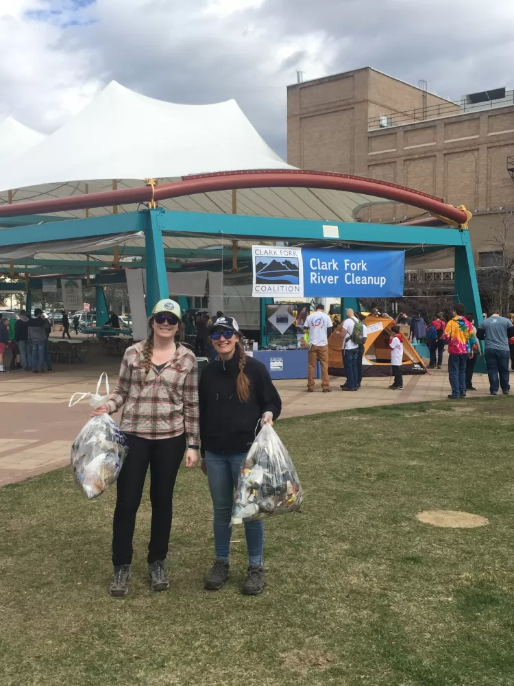 Adlifers Meg and Molly with full bags of collected trash in Caras Park after the cleanup