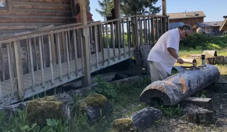 Mike Jackson carving a totem pole in the town of Kake, Alaska