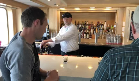 Ordering an Alaskan drink, the "Duck Fart", from the Chichagof Dream bar