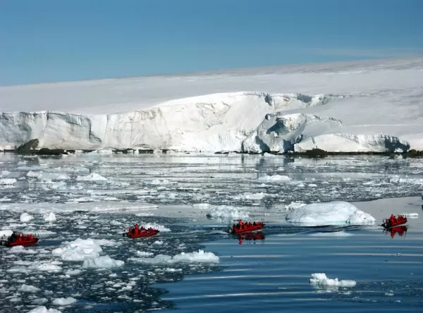 Zodiac cruising among icebergs