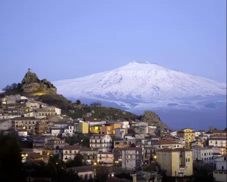 Blue hour over the city in the shadow of Mount Etna