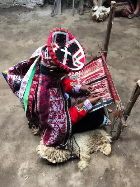 A local woman in Choquecancha weaving a piece of art.
