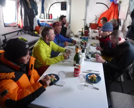 Eating a meal at South Pole Camp. Courtesy Rob Smith, Antarctic Logistics & Expeditions