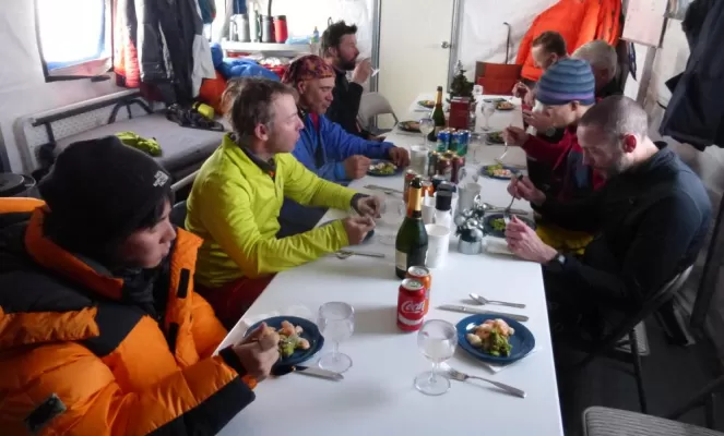 Eating a meal at South Pole Camp. Courtesy Rob Smith, Antarctic Logistics & Expeditions