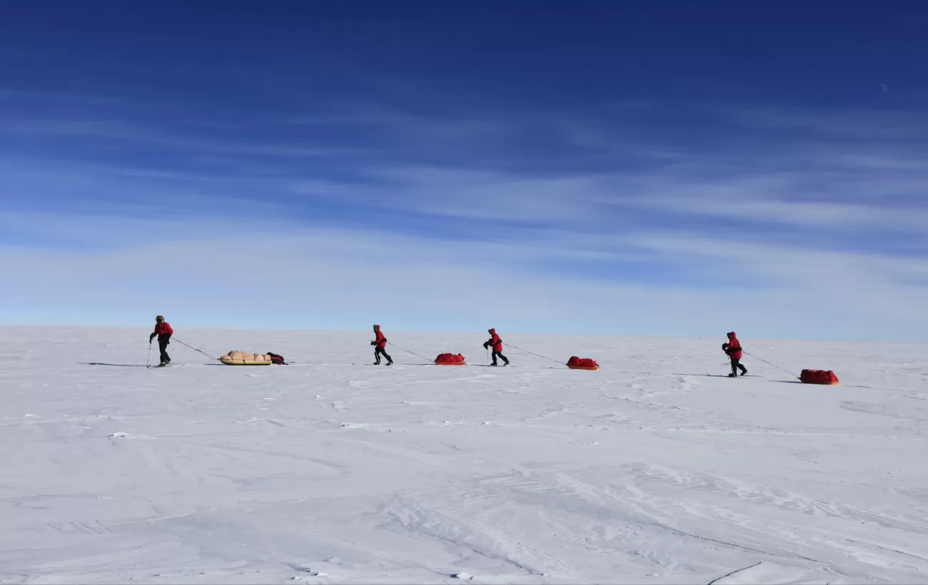 Skiers make their way to the South Pole pulling their sleds. Courtesy John Beatty, Antarctic Logistics & Expeditions