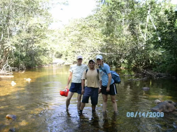 Wading through the river in route to the ATM cave
