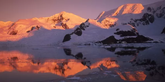 The sun sets over polar mountains