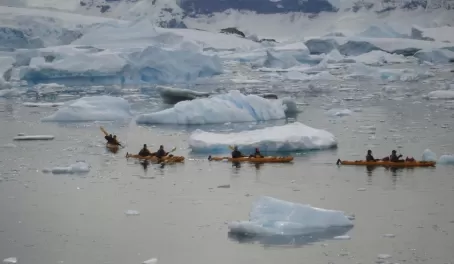 Kayakers work their way through ice at Curverville