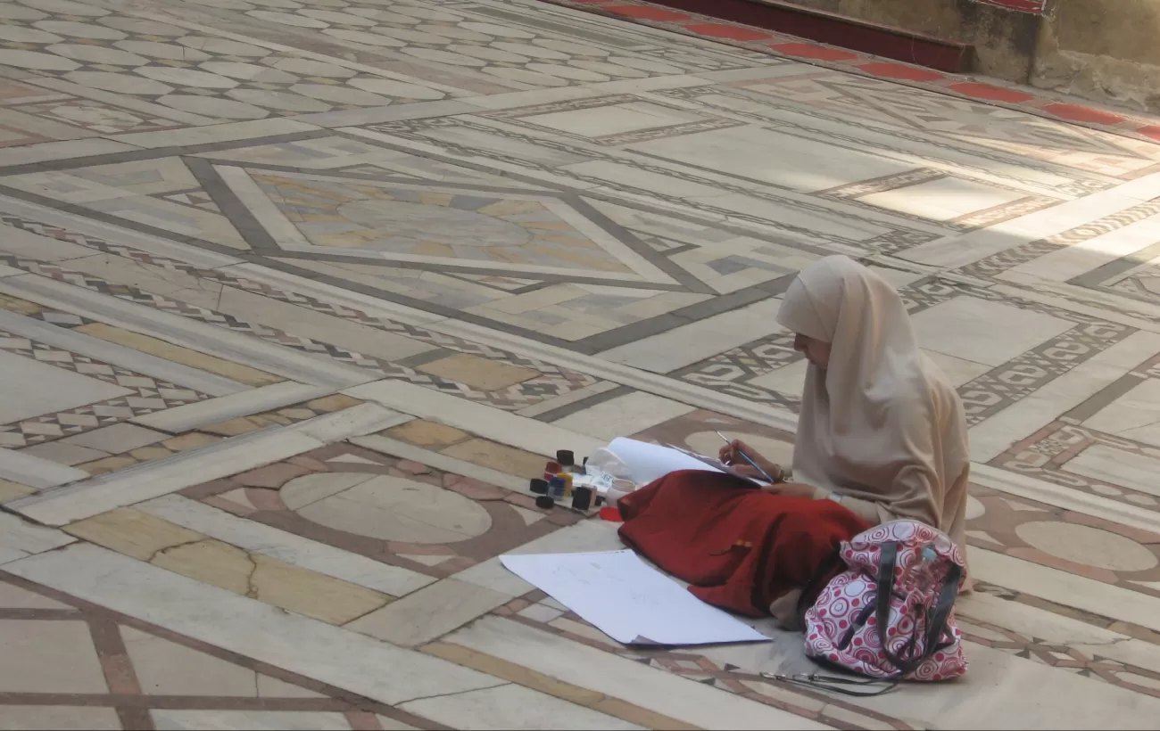 Woman drawing at mosque