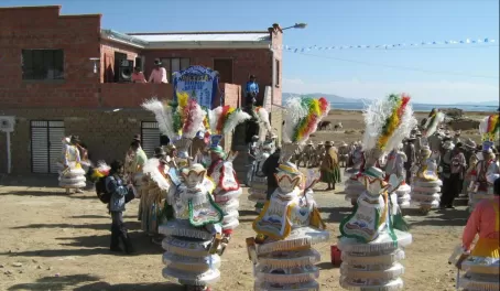 Street party with beautifully costumed dancers on the drive to La Paz