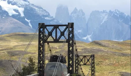 Crossing a suspension bridge in to Torres del Paine National Park