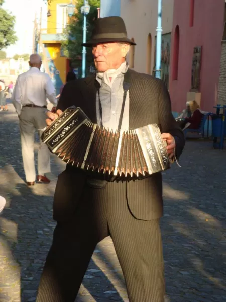 A man plays in the street
