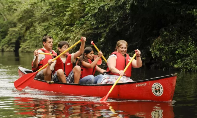 Family canoe trip through the rainforest