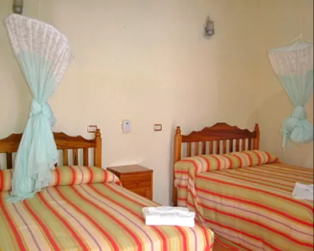 Rooms are equipped with mosquito netting and private bath facilities