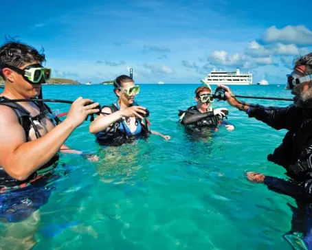 Travelers learning how to scuba dive.