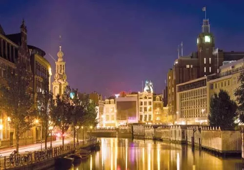 Watch the lights of Amsterdam reflect off the water of the city\s celebrated canals