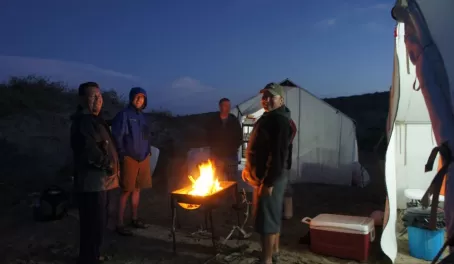 Gathering around the fire while camping in Baja