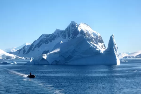 A massive iceberg dwarfs your approach during an Antarctica cruise