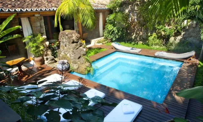 Relax on the pool deck at Pousada Casa da Turquesa