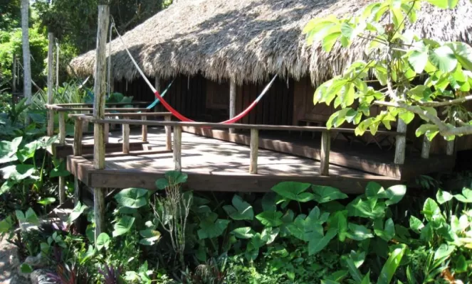 Relax on the deck at Lamanai Outpost Lodge