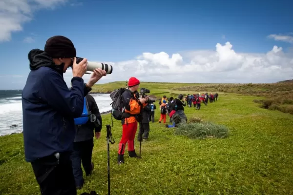 Travelers photographing the subantarctic landscape.