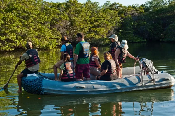 Travelers take a zodiac through the waters of the Galapagos.