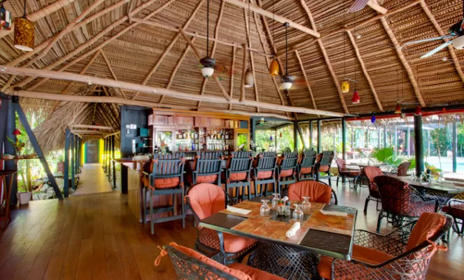 Relax in the dining room at Singing Sands Resort on your Belize tour