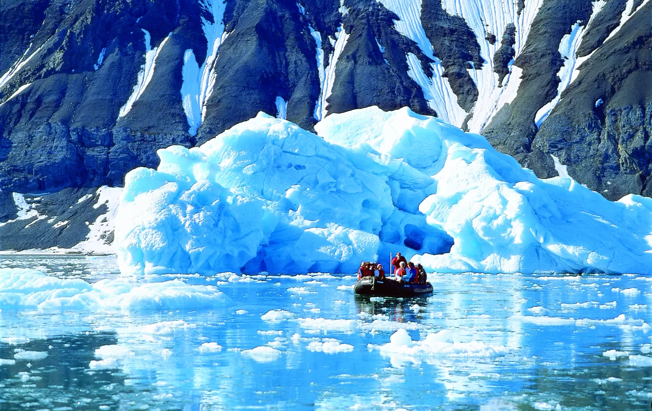 Taking a zodiac tour to see icebergs in the arctic.