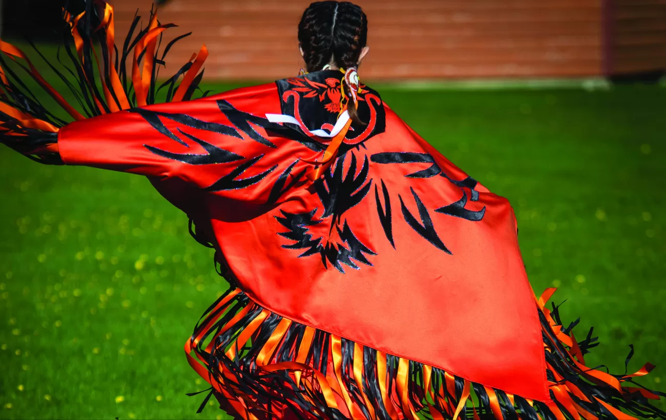 A local in native dress dances in traditional style.