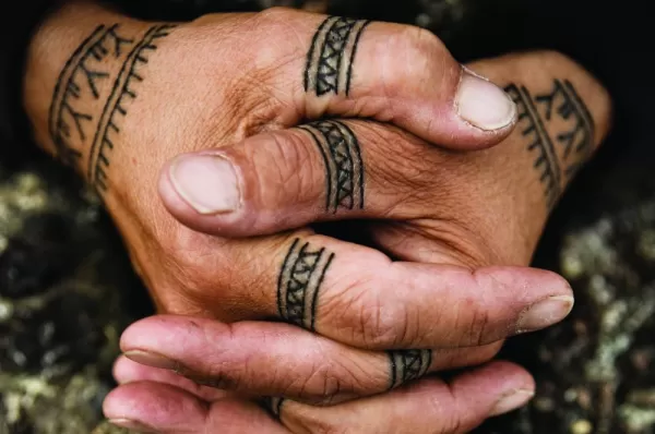 Cultural tattoos on the hands of a local.