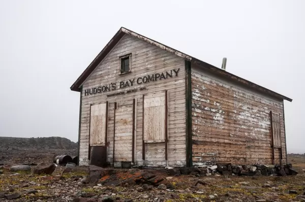 An old run down building with the Hudson's Bay Company sign on it.