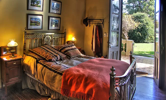 Guest rooms include large windows and an interesting array of period furniture