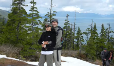 A couple makes it to the top of the mountain