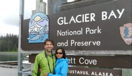 A couple poses at the entrance to Glacier Bay National Park