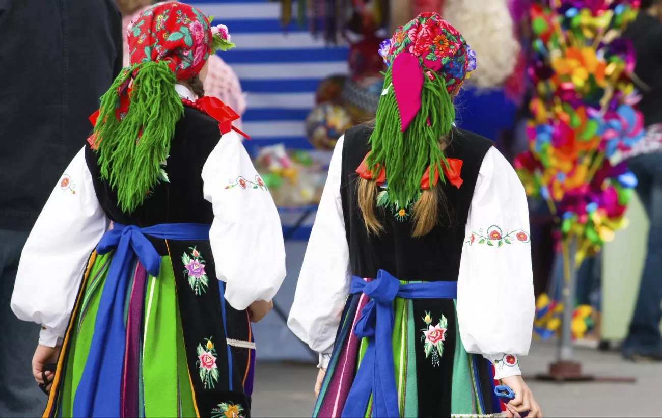 Locals of Poland wearing colorful traditional clothing.