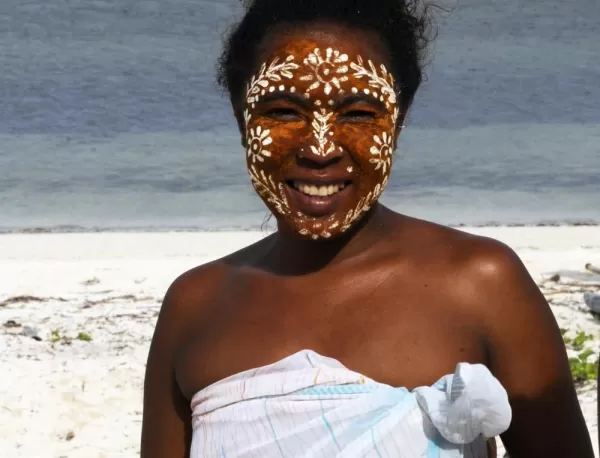 A local woman wears traditional face paint that protects the face from sun and mosquitoes.