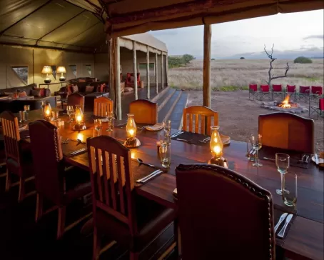 Enjoy a delicious meal while watching the sun set over the beautiful landscape.