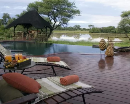 Relax by the pool and enjoy a refreshing drink at the Okonjima Bush Camp