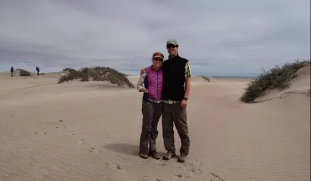 A couple pose on the desert sands of Namibia