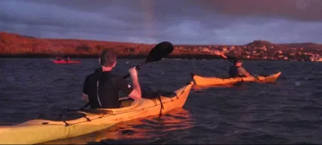 rainbow kayaking at sunset