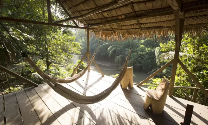 Relax in a hammock on the porch of the guest cabins