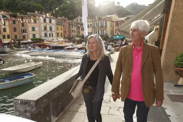 A couple walks through a romantic harbor in Europe