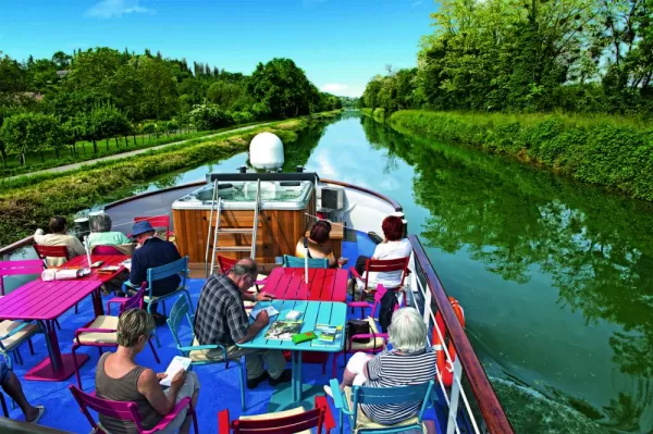 Relax on the decks of the MS Jeanine as you sail the canals of France