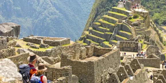Couple looks out over Machu Picchu