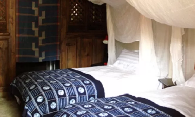 Twin beds and authentic accommodations await the traveler to the Laomadian Lodge