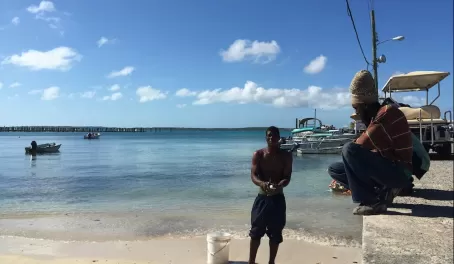 Cleaning conch on the dock in the Bahamas